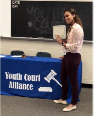 woman holding up certificate