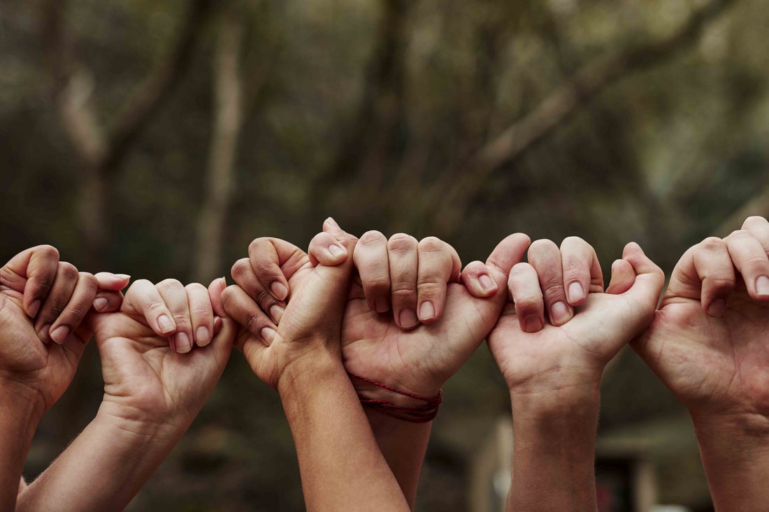 People holding hands together.