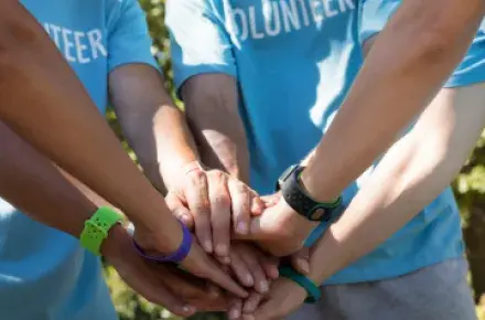 People with their hands in a circle.