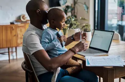 Father and son seating at the table.