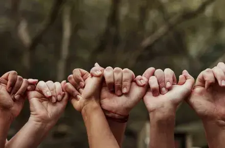 People holding hands together.