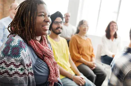 People sitting in a room listening to a presentation.