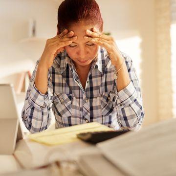 Woman stressed by paying bills