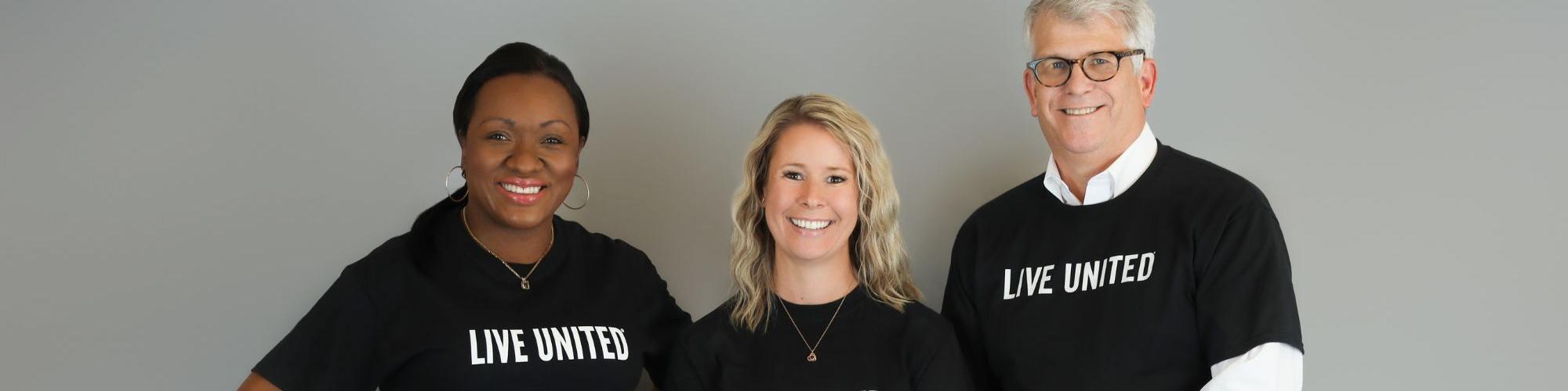 Three people smiling in LIVE UNITED shirts