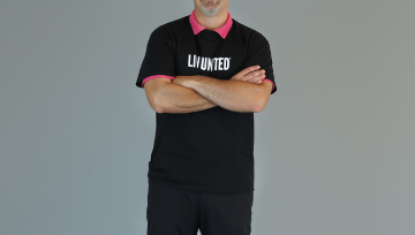 man standing with his arms crossed in a black live united shirt